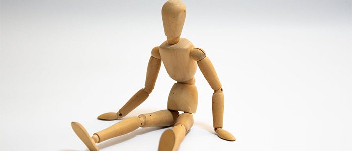 A wooden jointed figure in a seated position