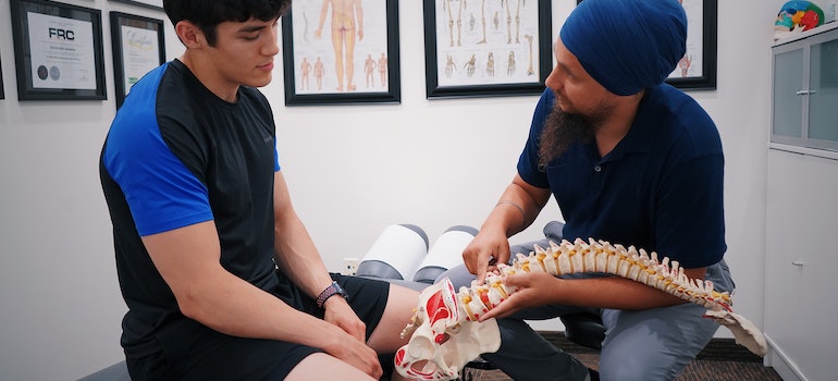 an expert explaining the health benefits of spinal decompression to a man