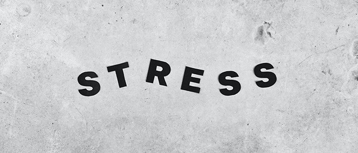 The word stress on a grey surface.